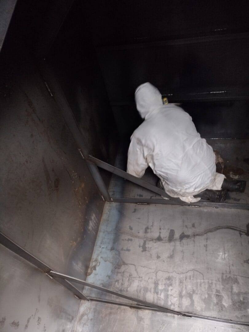 Cleaning a large diesel storage tank in Denver.